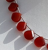 8 inch strand Carnelian Gemstone Twisted heart Briolette